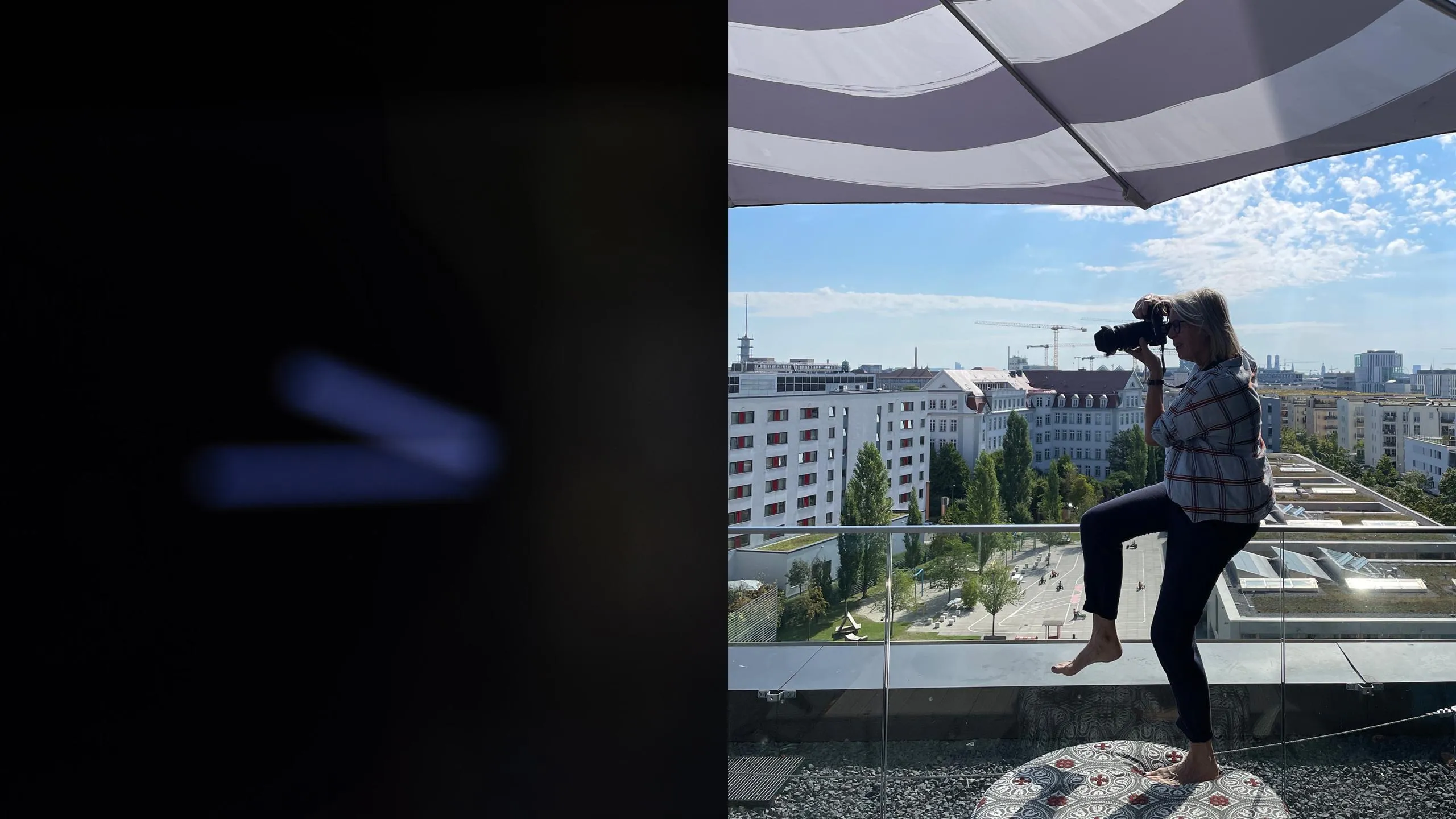 Person fotografiert auf einem Balkon. Stadtpanorama an einem sonnigen Tag im Hintergrund.